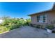 A concrete patio and a garden of varied shrubs and plants create a tranquil retreat at 2211 42Nd W St, Bradenton, FL 34205