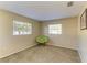 Neutral bedroom featuring natural light through windows, complemented by a green chair at 2211 42Nd W St, Bradenton, FL 34205