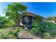 Exterior view of home's screened patio and landscaping with tropical plants at 2211 42Nd W St, Bradenton, FL 34205