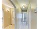 Hallway featuring an arched entryway and multiple doors, complemented by neutral walls at 2211 42Nd W St, Bradenton, FL 34205