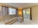 Living room with a sectional sofa and view to screened patio featuring tile floors and neutral walls at 2211 42Nd W St, Bradenton, FL 34205