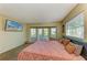 Bright main bedroom with carpet, French doors, and a modern TV at 2211 42Nd W St, Bradenton, FL 34205