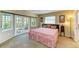 Bright main bedroom with carpet, French doors, and natural light at 2211 42Nd W St, Bradenton, FL 34205