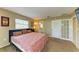 Cozy bedroom featuring carpet floors, a large bed, and a partial view of ensuite bathroom at 2211 42Nd W St, Bradenton, FL 34205