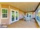 Relax on the home's screened patio featuring a tan floor, a table, and white chairs at 2211 42Nd W St, Bradenton, FL 34205