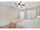 Bedroom featuring a neutral color scheme, ceiling fan, closet, and light wood-look flooring at 2211 Sunset Dr # E3, Bradenton, FL 34207