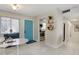 Dining area with a bright blue entry door, leading to a kitchen view with stainless steel appliances at 2211 Sunset Dr # E3, Bradenton, FL 34207