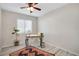 Home office with a vintage desk, ceiling fan and wood-look flooring at 2211 Sunset Dr # E3, Bradenton, FL 34207