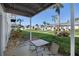 Outdoor patio with seating and a lush green lawn in a well-maintained community at 2211 Sunset Dr # E3, Bradenton, FL 34207