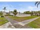 Community pool area surrounded by lush landscaping and a white fence, offering a serene retreat at 2211 Sunset Dr # E3, Bradenton, FL 34207