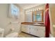 Bathroom featuring a vanity with a sink, a mirror with vanity lighting, and a tiled shower at 2407 Amanda Dr, Sarasota, FL 34232