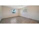 Bedroom with tile floors, two windows for natural light, and a ceiling fan at 2407 Amanda Dr, Sarasota, FL 34232