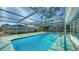 Relax in this screened pool featuring a stainless steel grab rail and an enclosed lanai at 2407 Amanda Dr, Sarasota, FL 34232