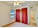 Bedroom with ceiling fan and red curtains at 2822 Maple Ave, Sarasota, FL 34234