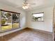 Bedroom with tile floors, ceiling fan, and large window at 2822 Maple Ave, Sarasota, FL 34234