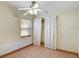 Bedroom with tile floors, window, and ceiling fan at 2822 Maple Ave, Sarasota, FL 34234