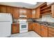 Updated kitchen with wood cabinets and granite countertops at 2822 Maple Ave, Sarasota, FL 34234