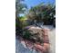 Private backyard with a small brick-lined garden and seating area surrounded by tropical landscaping at 2930 Tuckerstown Dr, Sarasota, FL 34231