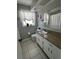 Well-lit bathroom with tile flooring and granite-style vanity top at 2930 Tuckerstown Dr, Sarasota, FL 34231