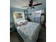 Sunlit bedroom with nautical-themed decor and a ceiling fan at 2930 Tuckerstown Dr, Sarasota, FL 34231