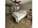 Comfortable bedroom features a ceiling fan, tile flooring and a neutral wall color at 2930 Tuckerstown Dr, Sarasota, FL 34231