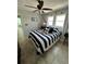 Tiled bedroom with a beach themed decor and a ceiling fan at 2930 Tuckerstown Dr, Sarasota, FL 34231