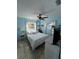 Sunlit bedroom with nautical-themed decor and a ceiling fan at 2930 Tuckerstown Dr, Sarasota, FL 34231