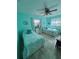 Bright, tiled bedroom featuring two twin beds and teal accents at 2930 Tuckerstown Dr, Sarasota, FL 34231