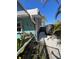 Exterior home view showing walkway lined with rock between home and black-covered boat at 2930 Tuckerstown Dr, Sarasota, FL 34231