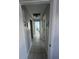 Hallway with tile flooring leading to bedrooms, offering a view of interior living space at 2930 Tuckerstown Dr, Sarasota, FL 34231