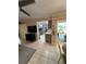 Living room leading into the kitchen and outdoor patio, all featuring tile flooring at 2930 Tuckerstown Dr, Sarasota, FL 34231