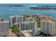 Beautiful aerial view of the condos by the bay with scenic ocean and island backdrop in clear blue sky at 301 Quay Commons # 1809, Sarasota, FL 34236