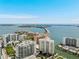 Aerial view of a waterfront condominium complex, showcasing its prime location and city skyline at 301 Quay Commons # 1809, Sarasota, FL 34236