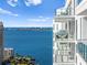 Condo balcony with seating offers stunning waterfront views perfect for relaxing and entertaining at 301 Quay Commons # 1809, Sarasota, FL 34236