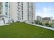 Well-maintained rooftop dog park with artificial turf, providing a pet-friendly amenity at 301 Quay Commons # 1809, Sarasota, FL 34236