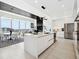 Open-concept kitchen with island, modern appliances, and sleek cabinetry at 301 Quay Commons # 1809, Sarasota, FL 34236