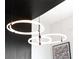 Modern light fixture with multiple rings and accents that enhance the room's design and style at 301 Quay Commons # 1809, Sarasota, FL 34236