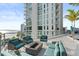 Inviting patio area with comfortable seating, a fire pit, and stunning views of the water at 301 Quay Commons # 1809, Sarasota, FL 34236