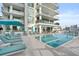 Resort-style pool area with lounge chairs and modern building backdrop at 301 Quay Commons # 1809, Sarasota, FL 34236