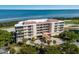 Aerial view of a luxurious condo building near the water at 3070 Grand Bay Blvd # 625, Longboat Key, FL 34228