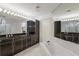 Elegant bathroom with double vanity, soaking tub, and marble floors at 3070 Grand Bay Blvd # 625, Longboat Key, FL 34228