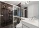 Bathroom with black and white tile, shower, and vanity at 3070 Grand Bay Blvd # 625, Longboat Key, FL 34228