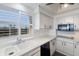 Clean, white kitchen with modern appliances and water views at 3070 Grand Bay Blvd # 625, Longboat Key, FL 34228