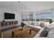 Bright living room with water views, comfy sofas, and a coffee table at 3070 Grand Bay Blvd # 625, Longboat Key, FL 34228