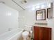 Bathroom featuring a vanity with granite countertop and a shower with tiled walls at 3273 Beneva Rd # 101, Sarasota, FL 34232