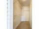 Walk-in closet features built-in shelving and a tiled floor for easy organization at 3273 Beneva Rd # 101, Sarasota, FL 34232