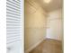 Walk-in closet features built-in shelving and a tiled floor for easy organization at 3273 Beneva Rd # 101, Sarasota, FL 34232