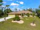 Single-story house with landscaped yard and driveway at 3273 Wentworth St, North Port, FL 34288