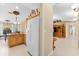 Kitchen with light wood cabinets and white appliances at 3273 Wentworth St, North Port, FL 34288