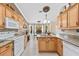 Bright kitchen with granite countertops and wood cabinets at 3273 Wentworth St, North Port, FL 34288